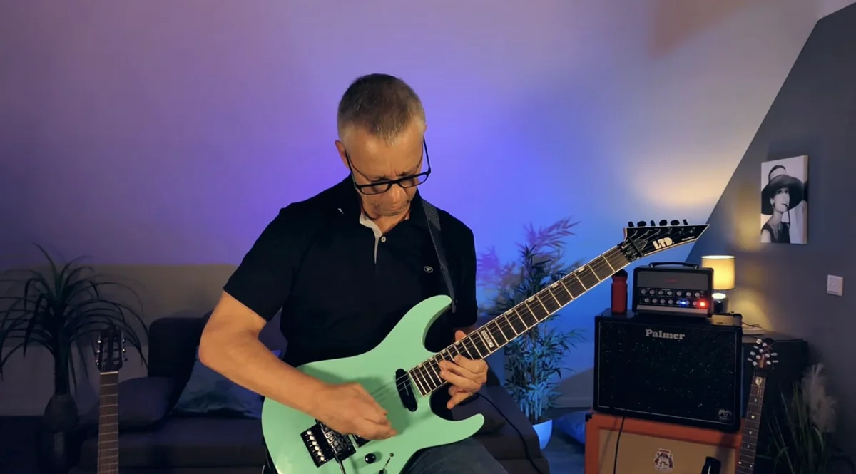 Joachim playing guitar in his studio